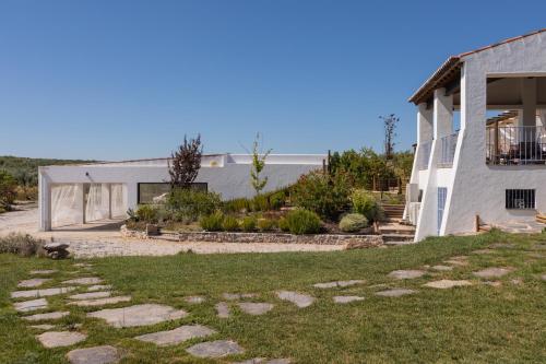 a house with a stone path in front of it at Monte da Estrela - Country House & SPA in Moura