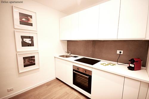 a kitchen with white cabinets and a stove at Albero della fortuna in Turin