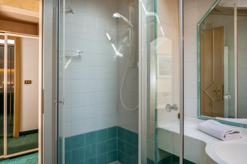 a bathroom with a shower and a sink at Albergo Contrin in Campitello