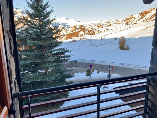a view of a snow covered mountain from a balcony at Chalet Los Ibones - Lodge Formigal in Formigal