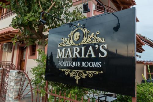 a sign for marias boutique royos in front of a building at MARIA'S BOUTIQUE Rooms in Kórinthos