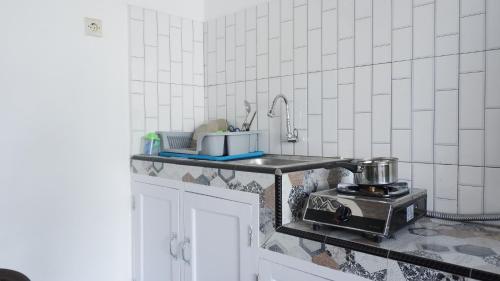 a kitchen with a sink and a mixer on a counter at Griya Joyo 2 Syariah in Malang