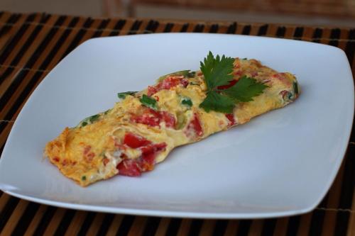 a slice of pizza on a white plate at Villa D'Uma in Ubud