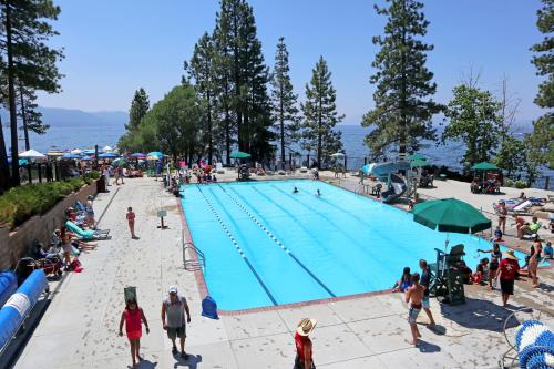 a large swimming pool with people at a beach at The Cozy Downtime Condo in Incline Village