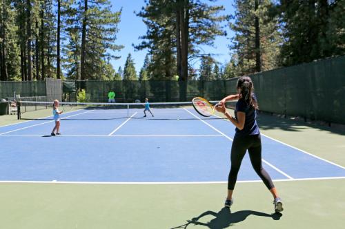 a group of people playing tennis on a tennis court at The Cozy Downtime Condo in Incline Village