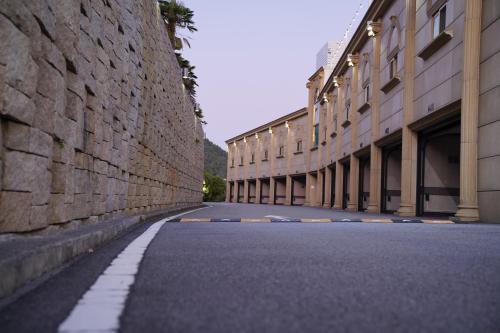 an empty street next to a brick wall at Hotel SANG SANG & Private SANG SANG POOL VILLA in Geoje 