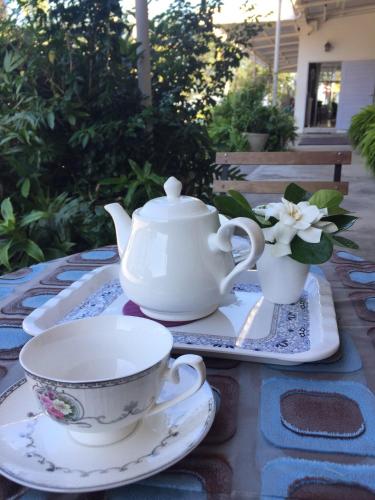 a table with a teapot and a tea cup and saucer at BC Summer Beach in Pran Buri