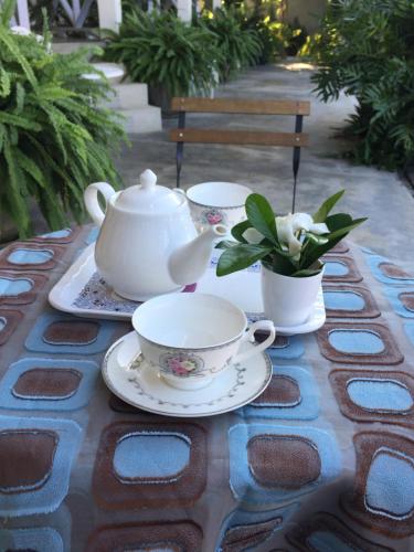 a table with two tea cups and a teapot at BC Summer Beach in Pran Buri