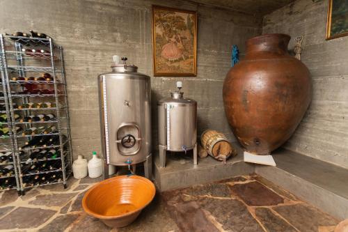 a room with a large vase and a sink and a jug at Monte da Estrela - Country House & SPA in Moura