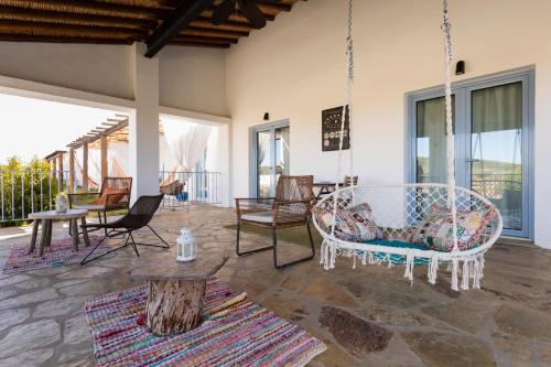 a porch with chairs and a swing at Monte da Estrela - Country House & SPA in Moura