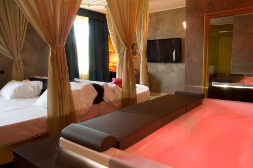 una camera d'albergo con due letti e uno specchio di HM MotelHotel a Castellazzo Bormida