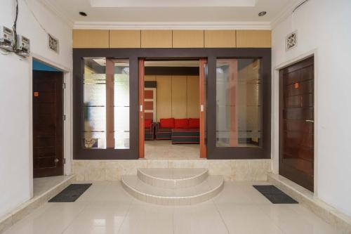 a lobby of a building with a waiting room at RedDoorz Syariah @ Mora Garden Bungo in Bebeko