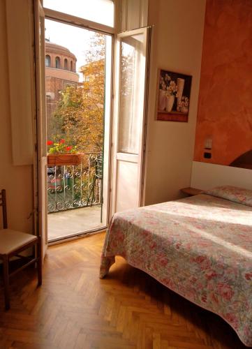 a bedroom with a bed and a sliding glass door at Hotel Giglio in Salsomaggiore Terme