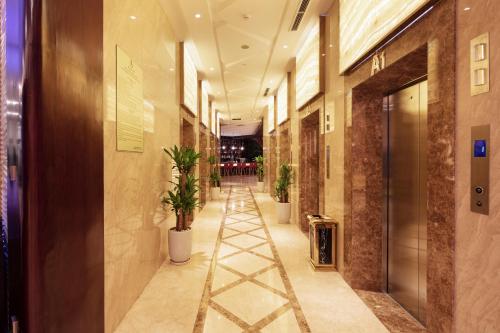 a hallway with potted plants in a building at Regalia Gold Hotel in Nha Trang