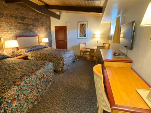 Ένα ή περισσότερα κρεβάτια σε δωμάτιο στο Dunes Inn Alamosa