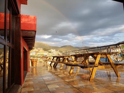 a row of wooden benches sitting on a building at Hotel Meson del Refugio in Guanajuato