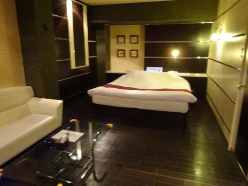 HOTEL Rplus 東松山にあるベッド