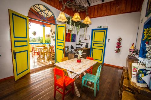 a dining room with colorful doors and a table and chairs at Hotel Bariloche in Santa Rosa de Cabal