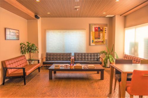 a living room with a couch and a table at K's House Kanazawa - Travelers Hostel in Kanazawa