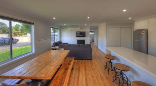 a kitchen with a table, chairs and a refrigerator at Yarrawonga Holiday Park in Yarrawonga
