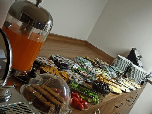 a table with a bunch of sandwiches and a drink at Hotel Kervansaray in Erzurum