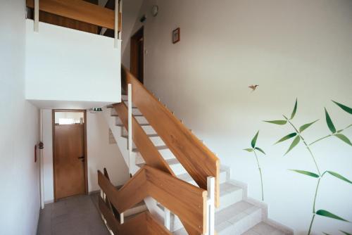 a staircase in a house with a stair case at Hotel Maj Inn in Moravske Toplice