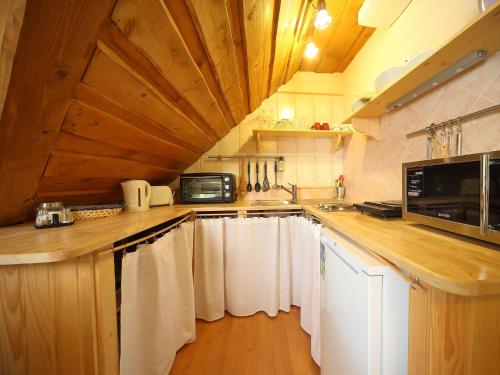 a kitchen with white towels hanging on the counter at Vila Edelweiss Rooms&App Kranjska Gora in Kranjska Gora