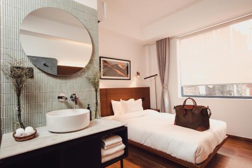 a bedroom with a sink and a large mirror at Nomad Hotel in Kathmandu