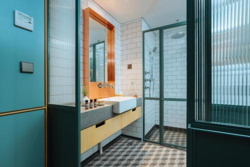 a bathroom with a sink and a mirror at KLoe Hotel in Kuala Lumpur