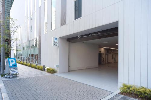 an entrance to a building with a parking garage at Hearton Hotel Kita Umeda in Osaka