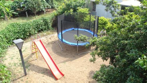 a playground with a slide and a play structure at Heritage Resort Hampi in Hampi