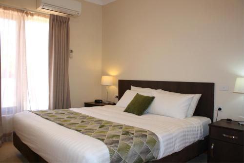 A bed or beds in a room at BIG4 Stuart Range Outback Resort