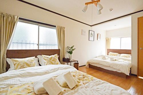 Postel nebo postele na pokoji v ubytování YUZU HOUSE
