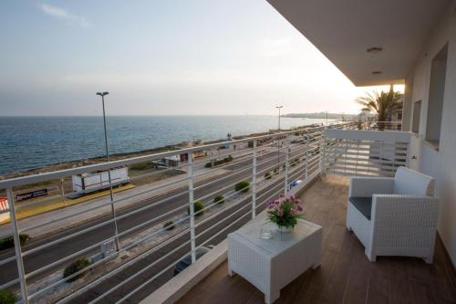 a balcony with a view of the ocean and a highway at Spuma di mare in Gallipoli