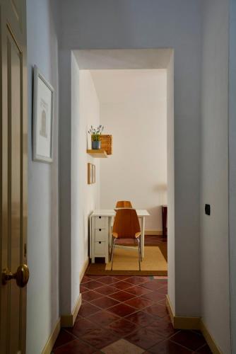 a hallway with a table and a chair at Roma Resort Termini in Rome