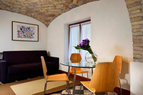 a living room with a table and a couch at Roma Resort Termini in Rome