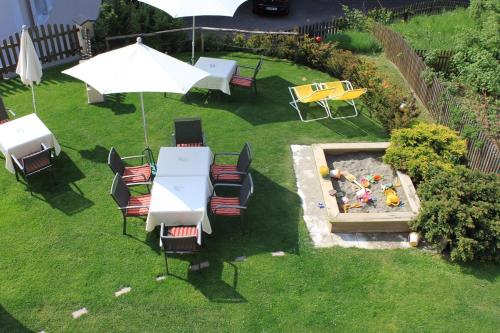 an overhead view of a table and chairs and an umbrella at Gasthaus Babsi in Soprabolzano