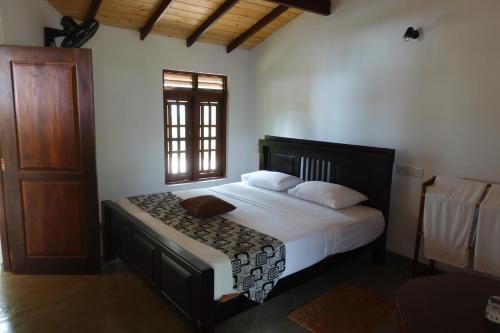 A bed or beds in a room at Ganesh Garden Beach Cabanas