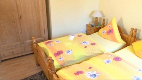 a bedroom with two beds with flowers on them at Hotel Alt Wassenberg in Wassenberg
