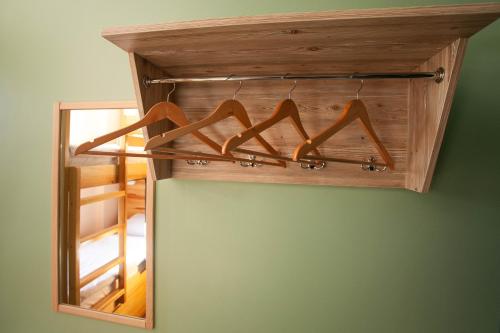 a mirror with a bunch of wooden hangers at DREAM Hostel Khmelnytskyi in Khmelʼnytsʼkyy