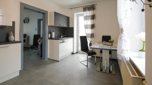 a kitchen with a table and a desk in a room at Haus Renè in Villach