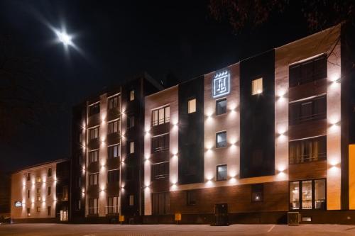 a building with lights on it at night at Hotel Lantier Wellness & Spa in Bytom
