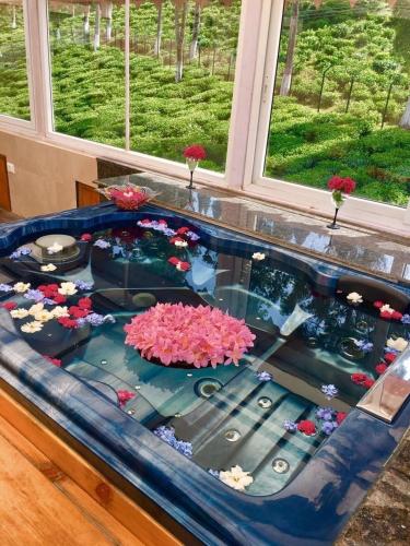 a fish tank with flowers in it next to a window at Sourenee Tea Estate in Mirik