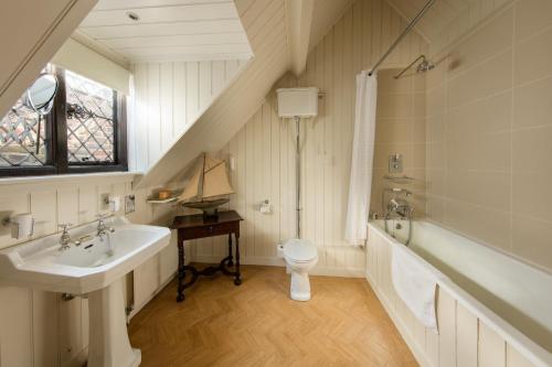a bathroom with a sink and a toilet at Great Fosters - Near Windsor in Egham