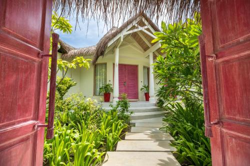 an open door to a house with a garden at Milaidhoo Maldives in Baa Atoll