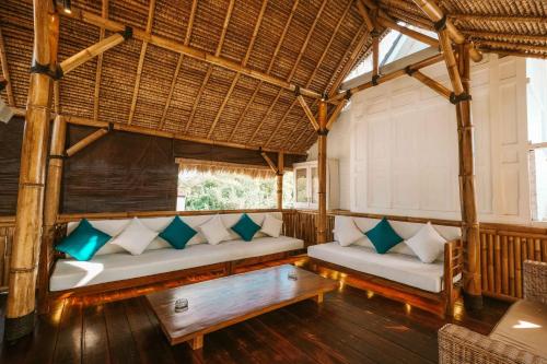 a living room with two couches and a table at The Palms Canggu in Canggu