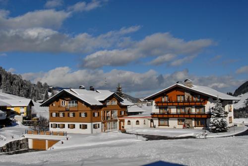 a ski lodge in the snow with snow covered buildings at Gästehaus Mathies in Mittelberg