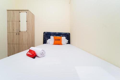 a bedroom with a bed with two towels on it at KoolKost Syariah at Green Lake City in Gondrong