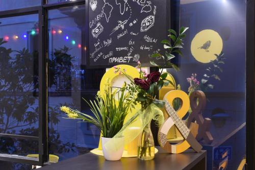 a table with flowers and a sign in a store window at Free Hostels Barcelona in Barcelona