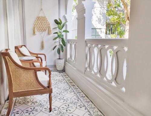 a room with two chairs and a window at The Inside House in Chiang Mai